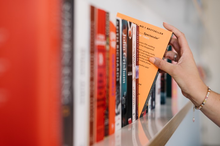 Grabbing a book from a shelf.